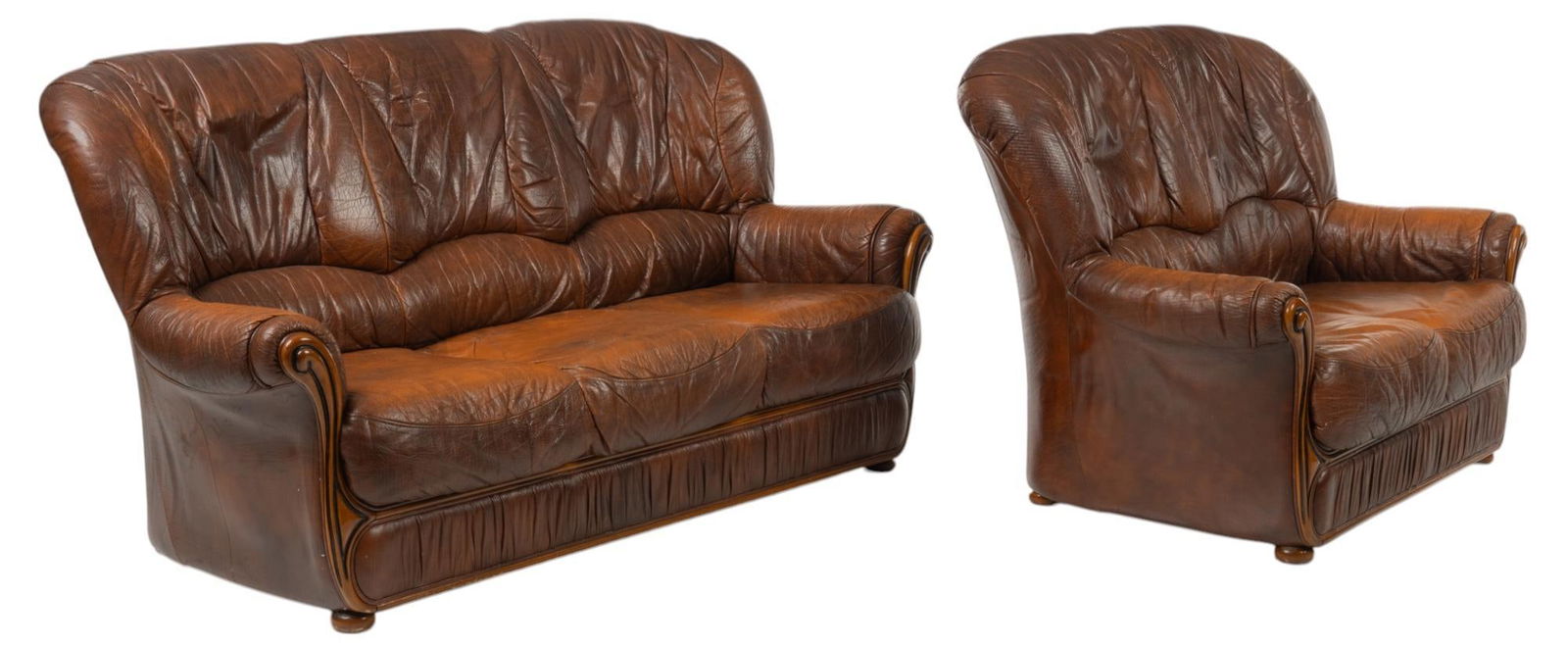 Farmhouse Leather Parlor Set: Farmhouse parlor set, includes leather sofa, and armchair, with matching carved scrolls on wooden frame, on bun feet height 37 in. x width 68 in. x depth 32 in.
