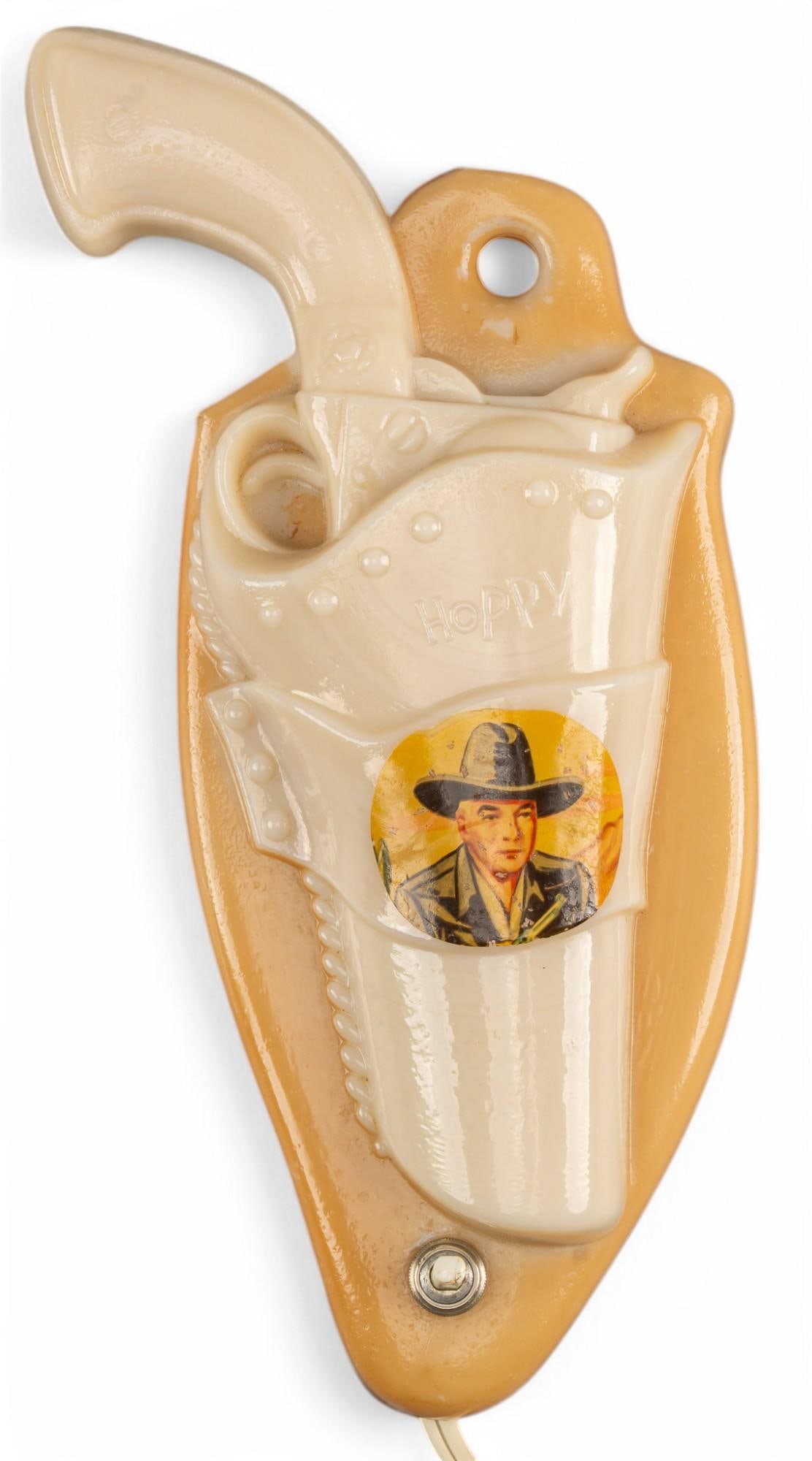 Hoppalong Cassidy Gun Holster Lamp: Aladdin Lamp Co. Hopalong Cassidy gun holster electric wall lamp, circa 1950s, in working condition height 10 in. x width 5 in. x depth 2 in. Provenance: Property from the collection of a Bluffton, In