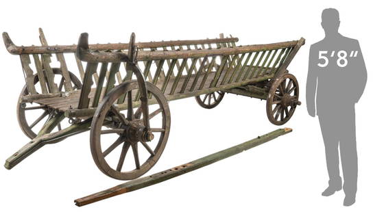 Primitive Style Hay Wagon: Sixteen-foot-long primitive style hay wagon, slatted sides and open ends, long handle, supported oniron banded spoke wheels height 53 in. x width 192 in. x depth 75 in.
