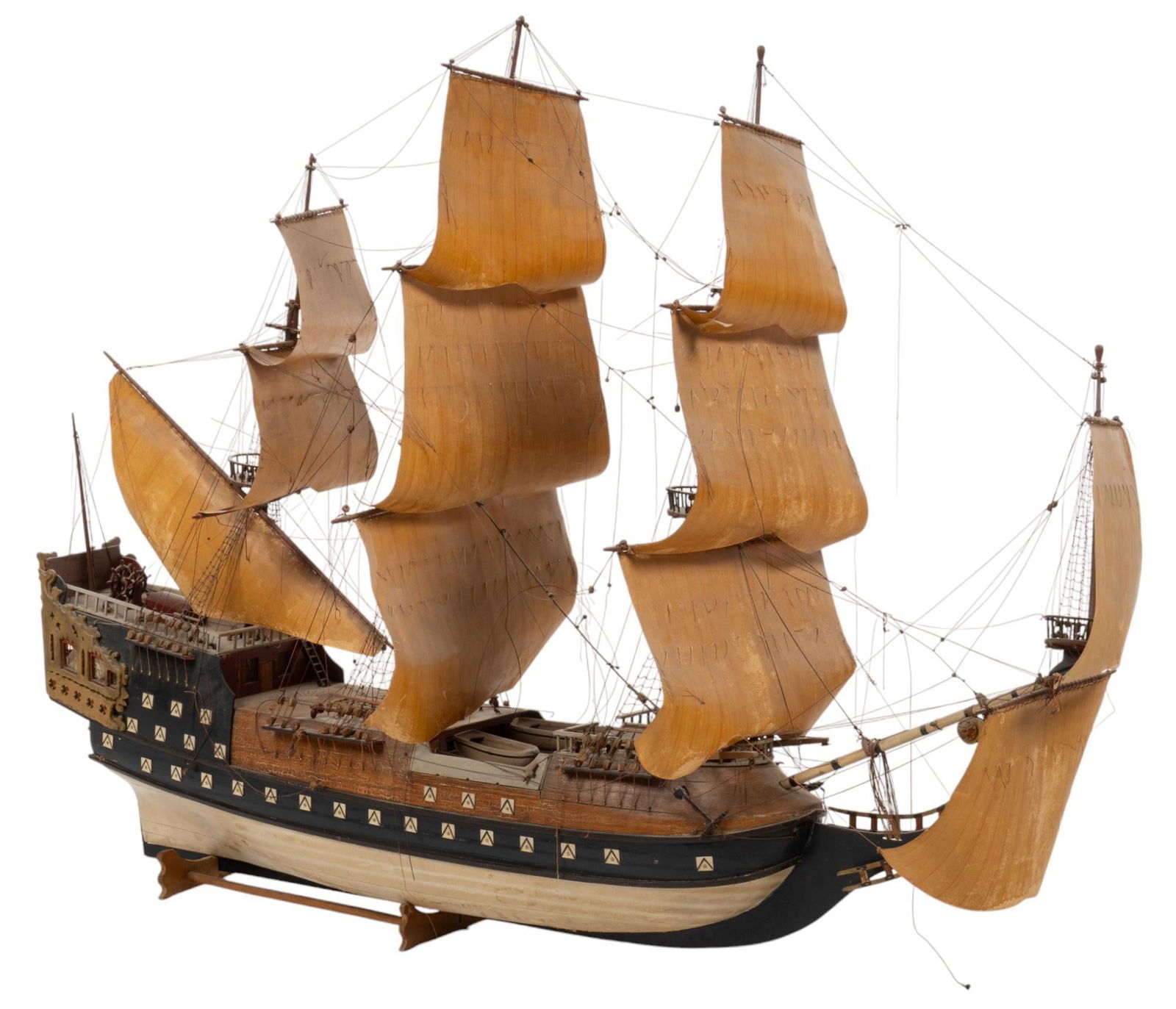 Vintage Model Naval Warship: Vintage model naval warship, natural stained wood with painted blue accents, with multiple decks with gun ports, canvas sails with ropes, and miniature deck equipment, supported on wooden base height