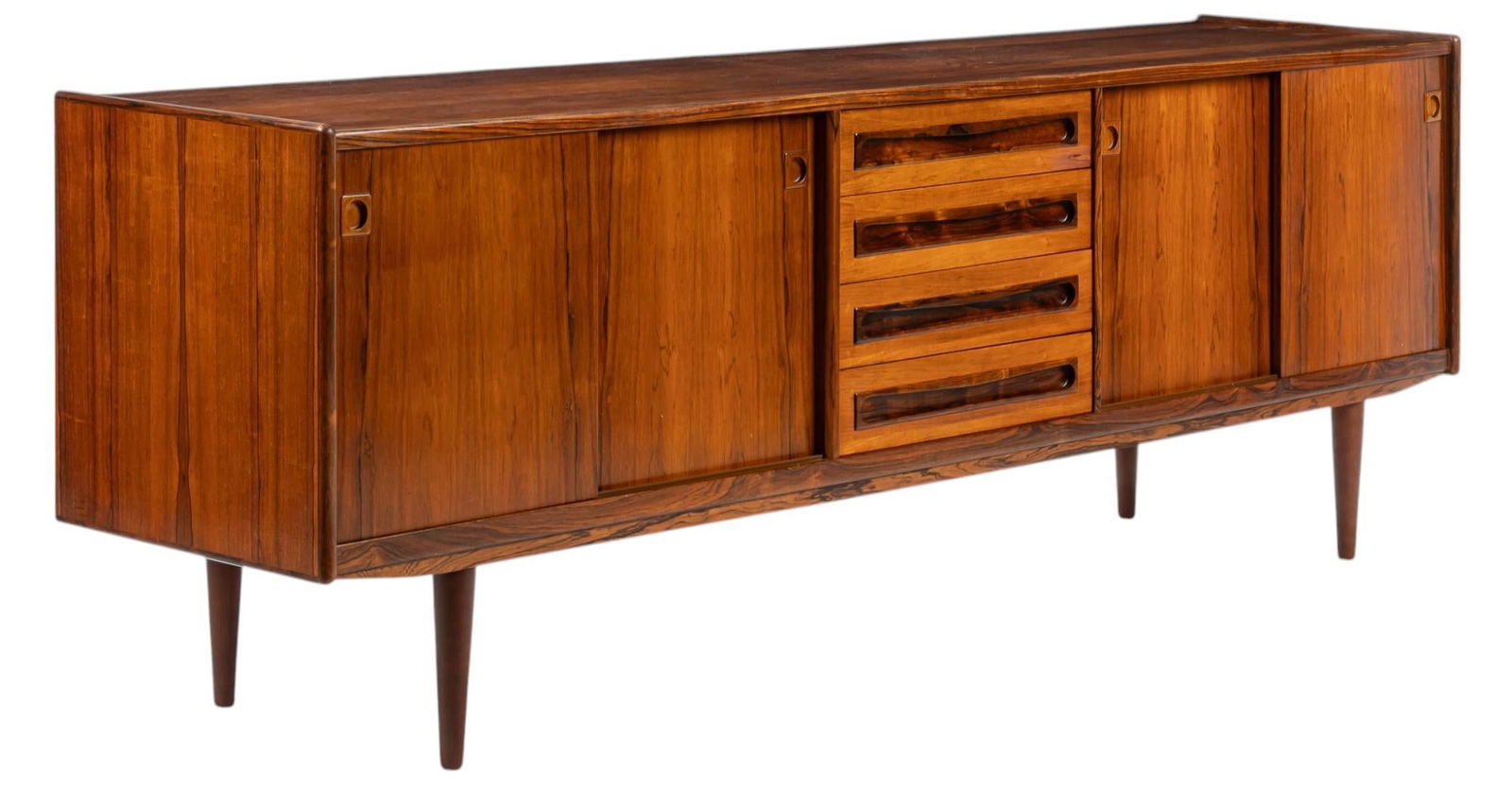 Mid-Century Danish Credenza: Mid-century Danish credenza with pairs of sliding doors with integrated wooden pulls, opening to shelved storage and felt-lined drawers, flanking three central drawers with integrated wooden pulls, ra