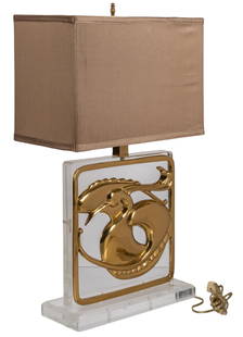 Chapman Lucite and Brass Lamp: Table lamp by Chapman Manufacturing Company (USA), with thick square-shaped lucite base, and brass egret and fish motifs, in working condition height 26 in. x width 16 in. x depth 8 in. Provenance: