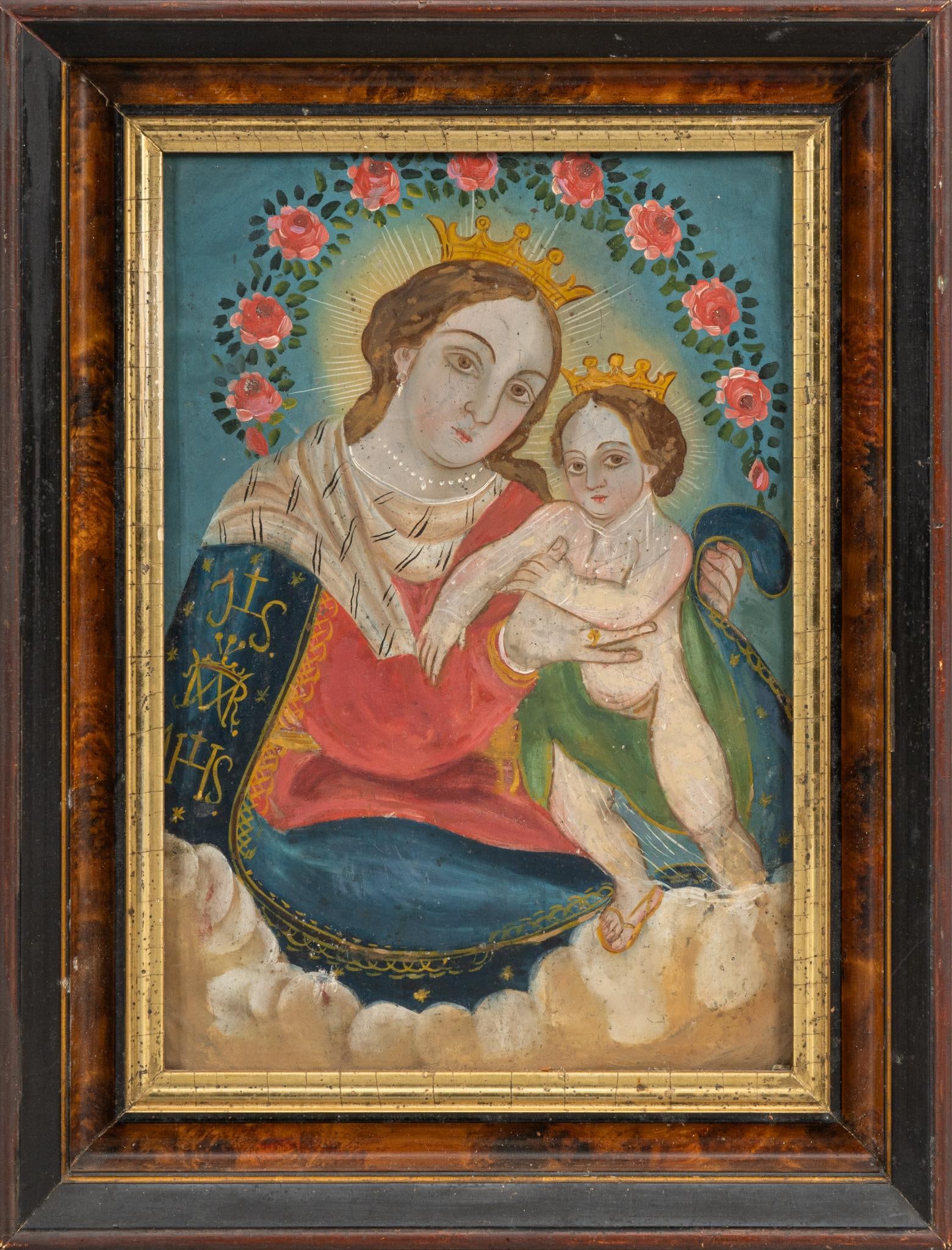 Mexican Retablo, Madonna and Child: Mexican retablo depicting Madonna and Child with crowns against blue background with a garland of roses, oil on metal, housed in a decorative wooden frame frame: 16.5 in. x 13 in., sight; 12 in.