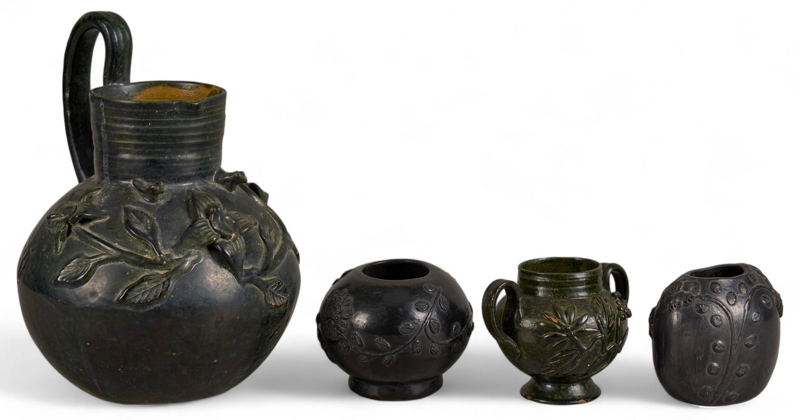 Collection of Oaxaca Pottery Vessels: Collection of four Oaxaca pottery vessels, to include large pitcher with floral decoration and three smaller containers, some signed, with examples by Dona Rosa (San Bartolo Coyotepec, Oaxaca) height 