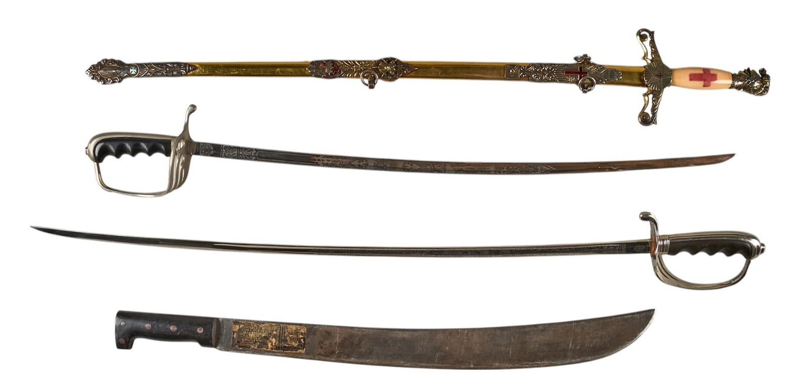 Lot of 4 Swords and Machete: US M1902 Sabers, Fraternal Sword and 1942 US Legitimus: Includes: -pair of US M1902 sabers; etched blades; w/ scabbards; (1) E & F Horster Solingen-Germany; (2) Colonial-Spain -named Fraternal sword; Texas marked crossguard; blade etched w/ name "W