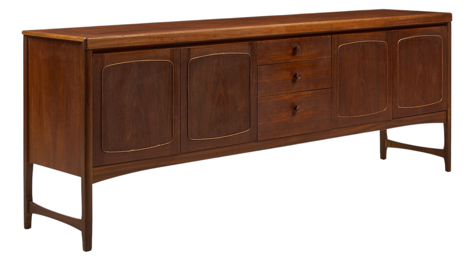 English Mid-Century Credenza: English mid-century credenza with central stack of three drawers and four cabinet doors that open to interior storage with small shelf, supported on block legs height 31 in. x width 84 in. x dept