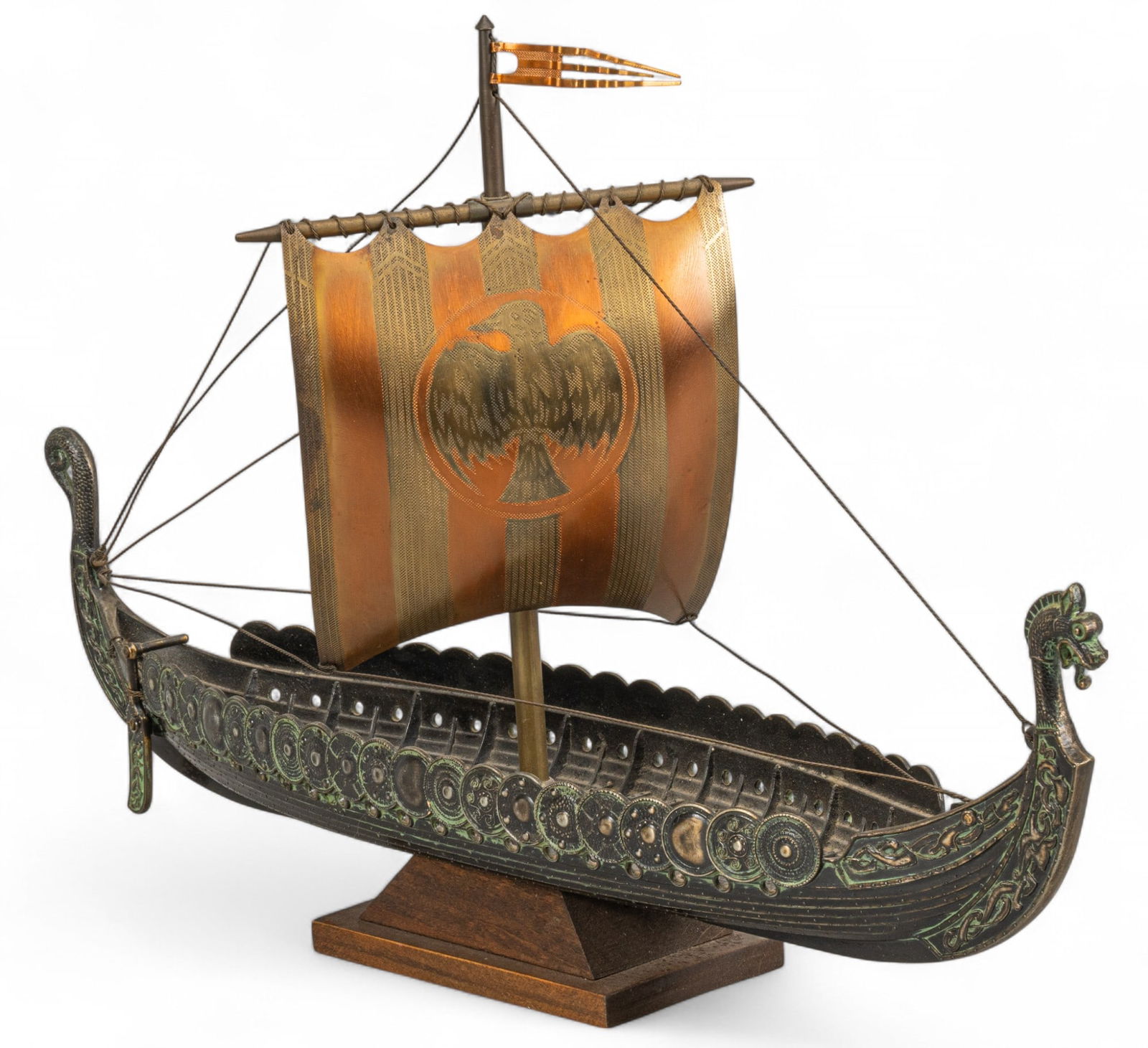 Edward Aagaard, Metal Viking Ship Model: Edward Aagaard (Denmark), Viking model ship, iron with copper sail, supported on wooden stand height 11 in. x width 16.5 in. x depth 5 in. Provenance: Property from a home in San Marcos, Texas