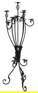 Wrought Iron Seven-Light Candelabrum: Standing iron candelabrum with seven candle holders, decorative leaf design at the base and twisted ironwork on the upper candle arms height 57 in. x width 21 in. x depth 21 in. Provenance: Property f
