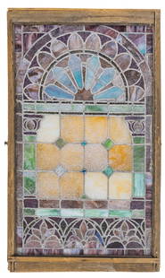 Stained Glass Window: Antique stained glass window featuring a geometric design with floral accents, encased in a wooden frame height 52&nbsp;in. x width 31 in. x depth 2.5 in. Provenance: Property from a Boerne, Texas hom