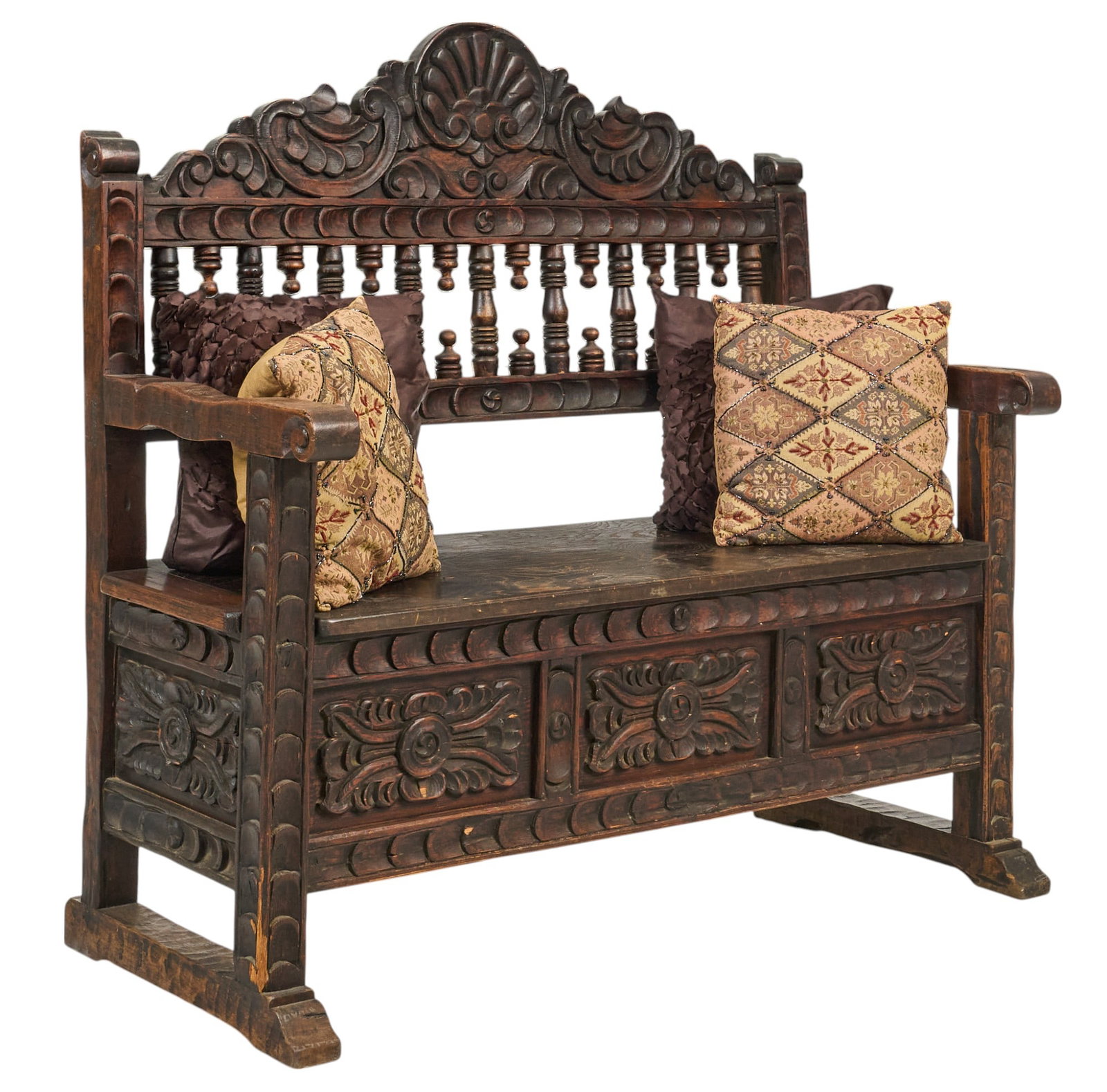 Carved Wooden Hall Bench: Carved wooden hall bench with storage, carved back, armrests, and a storage compartment beneath the hinged seat, includes decorative pillows height 52 in. x width 53 in. x depth 24 in. Provenanc