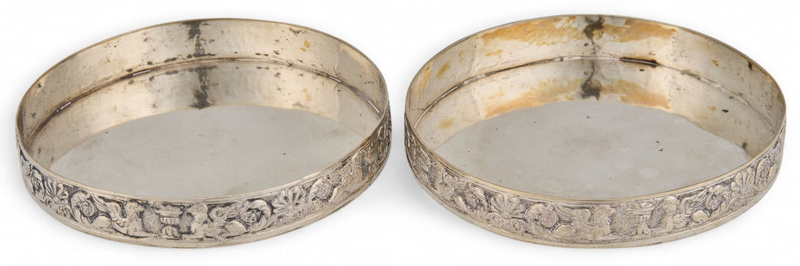 Pair of .800 Fine Silver Wine Bottle Coasters: Pair of .800 fine silver wine bottle coasters, marked ".800" Diameter: 3.75 in. Total weight: 4.50 ozt Provenance: Property from the collection of a San Antonio, Texas oil and gas entr