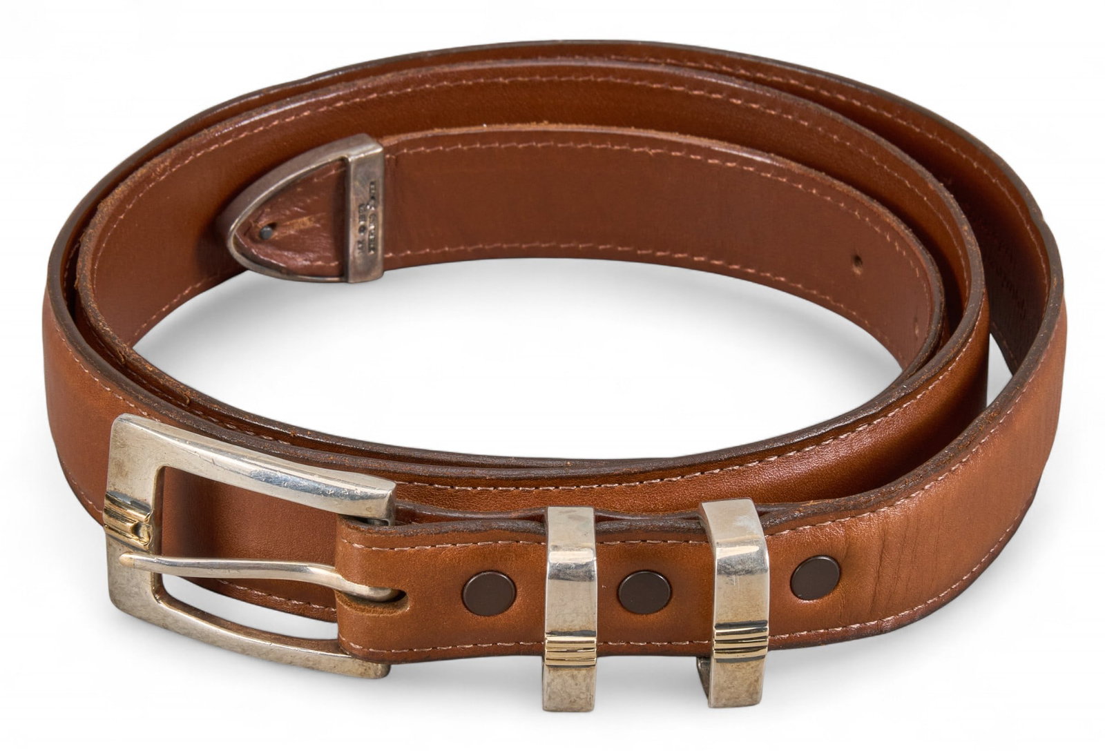 Brown Calfskin Belt: Brown calfskin belt with sterling silver and 14K inlay belt buckle, marked "Genuine Calfskin Sterling Silver 14K" Length: 42 in. Provenance: Property from the collection of a San Anton