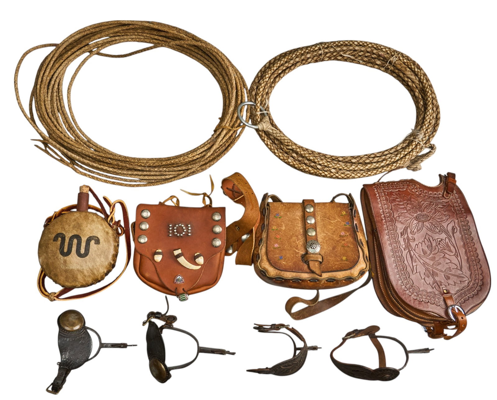 Lot of Leather Goods and Riding Gear: Lot of various leather goods and riding gear to include two unmarked Mexican style spurs, two lariats, a King Ranch branded rawhide wrapped canteen, Buffalo Arms Co. embossed leather cavalry