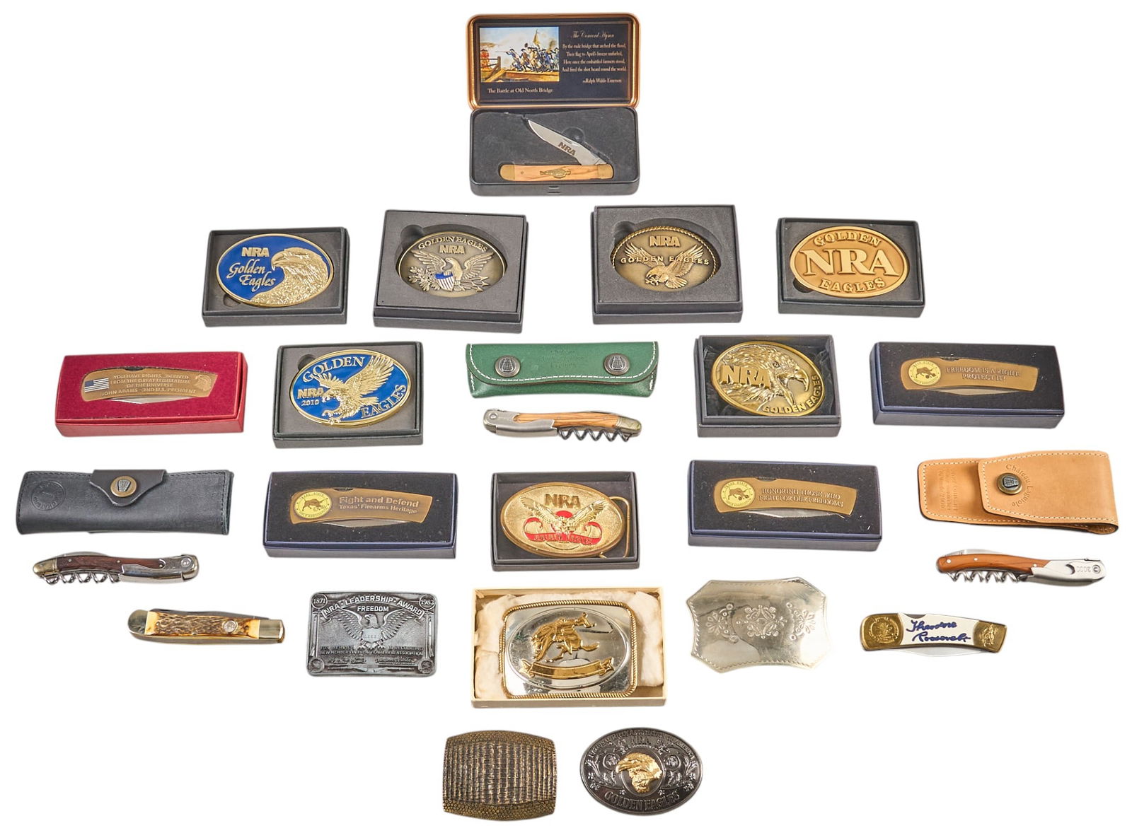 NRA Belt Buckles & Pocket Knife Collection: Collection of NRA belt buckles and pocket knives, featuring a variety of designs and materials, with boxed and individual pieces Provenanc
