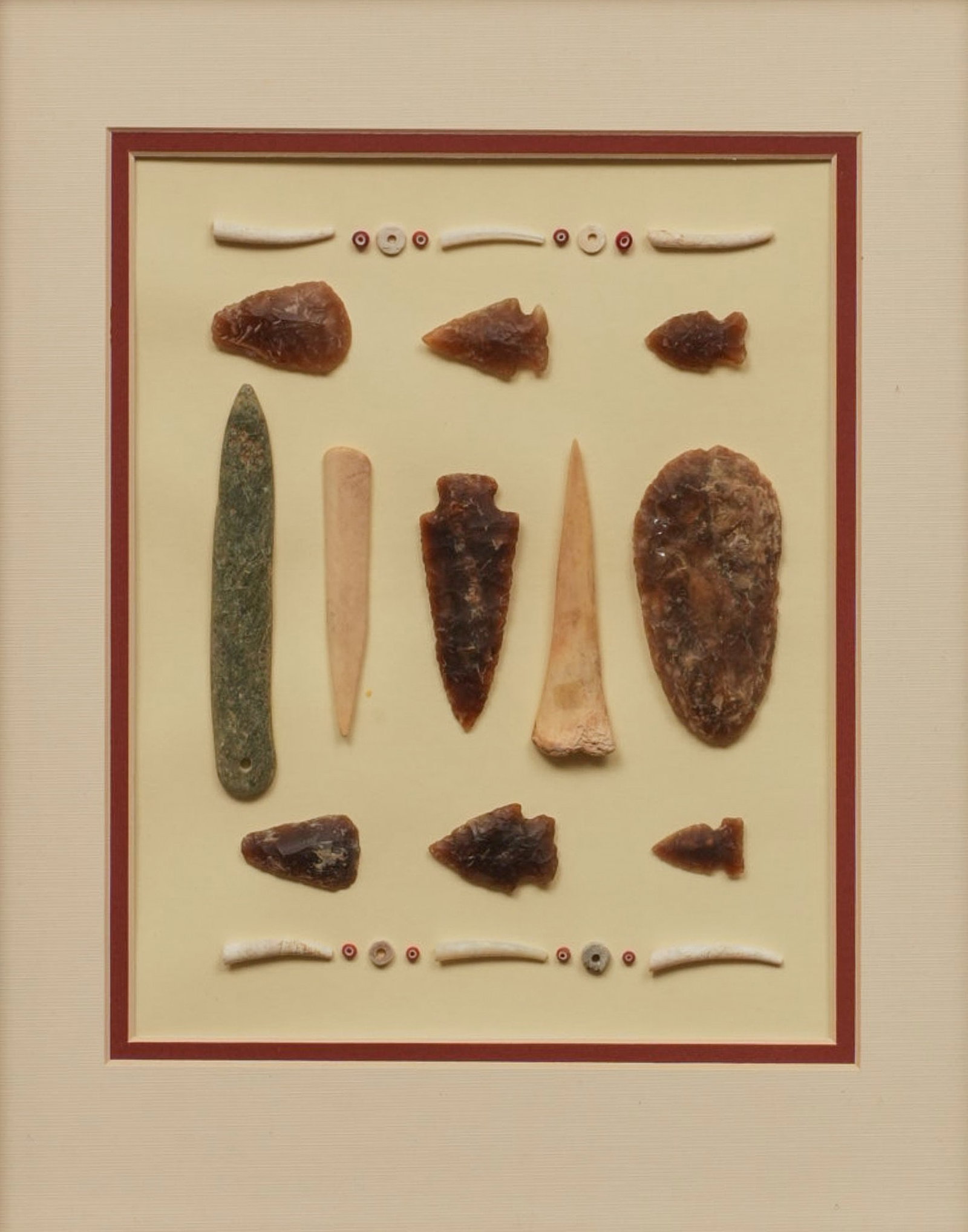 Native American Artifacts and Implements: Framed collection of Native American implements and trade beads gathered on the Edwards Ranch in the 1960s from the site of a large Ma
