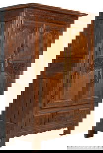 Antique Carved Armoire: Antique carved wooden armoire, with brass details to front, carved cabinet doors opening to two drawers and shelved storage, detailed carvings throughout, carved skirt, raised on shaped block feet, ma