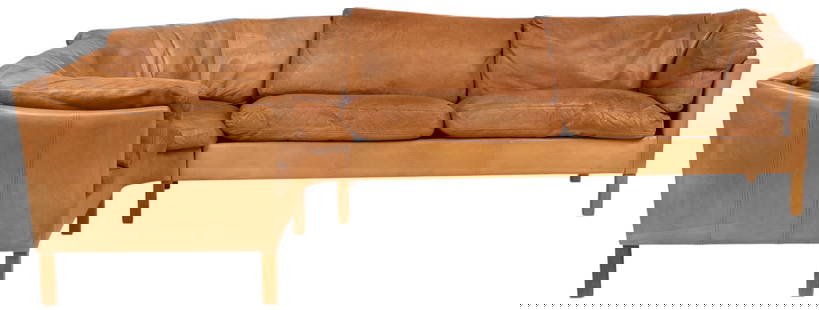 Danish Mid-Century Sofa: Danish mid-century brown leather sofa, with removable cushions, in L-shape, on wooden block legs height 30 in. x width 104 in. x depth 24 in. Provenance: Imported directly from Denmark to Vogt Auction