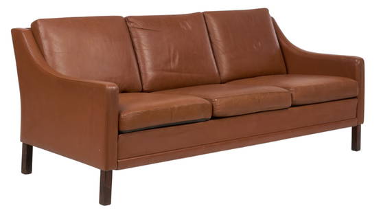 Danish Mid-Century Sofa: Danish mid-century sofa with reddish brown leather upholstery, supported on wooden block legs height 30 in. x with 72.5 in. x depth 32 in. Provenance: Imported directly from Denmark to Vogt Auction, c