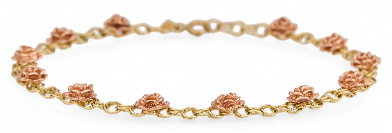 14K Floral Bracelet: 14k yellow gold bracelet with pink-toned rosette motifs, marked "14k" Circumferance: 6.75 in. Total weight: 5.46 g Provenance: Property from the collection of a prominent San Antonio, T