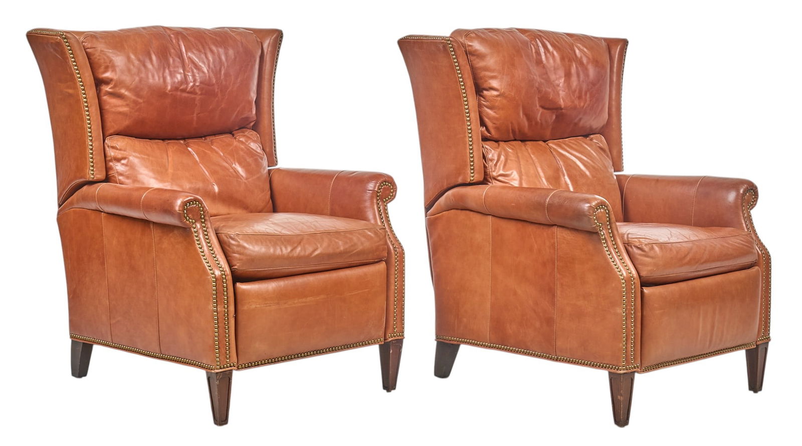 Pair of Louis Shanks Leather Recliners: Pair of leather recliners by Louis Shanks (Austin, Texas), with orange leather featuring nailhead trim, padded armrests, on tapered block legs height 41 in. x width 32 in. x depth 36 in. / each Proven