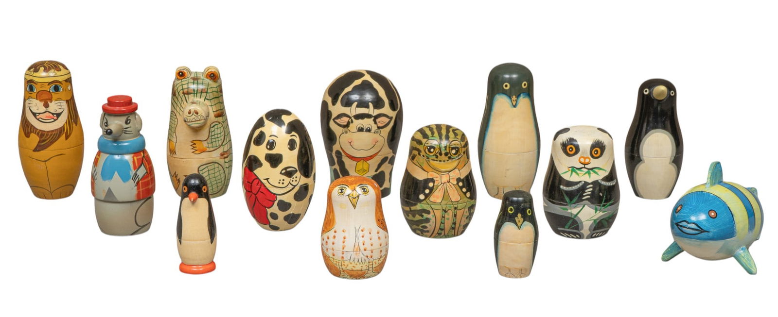(13) Russian Matryoshka Nesting Dolls, Animals: Collection of thirteen Russian Matryoshka nesting dolls, hand-painted with animal forms, includes penguins, fish, lion, dalmation, panda, rat, owl, cow, and alligator height 5.5 in. x diameter 3.