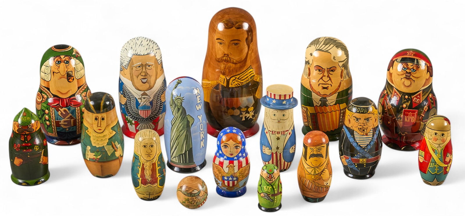(16) Russian Matroyshka Nesting Dolls, Political: Set of sixteen Russian Matroyshka nesting dolls, each hand painted with political characters and designs, includes Bill Clinton, George Washington, KGB agents, and Uncle Sam height 11 in x w