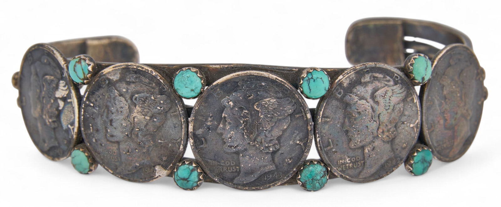 Silver Dime Sterling Silver Cuff: Sterling silver cuff featuring give silver dimes accented by small turquoise stones, marked "Buffalo Dancer" circumference: 7 in. total weight: 1.05 ozt Provenance: Property from
