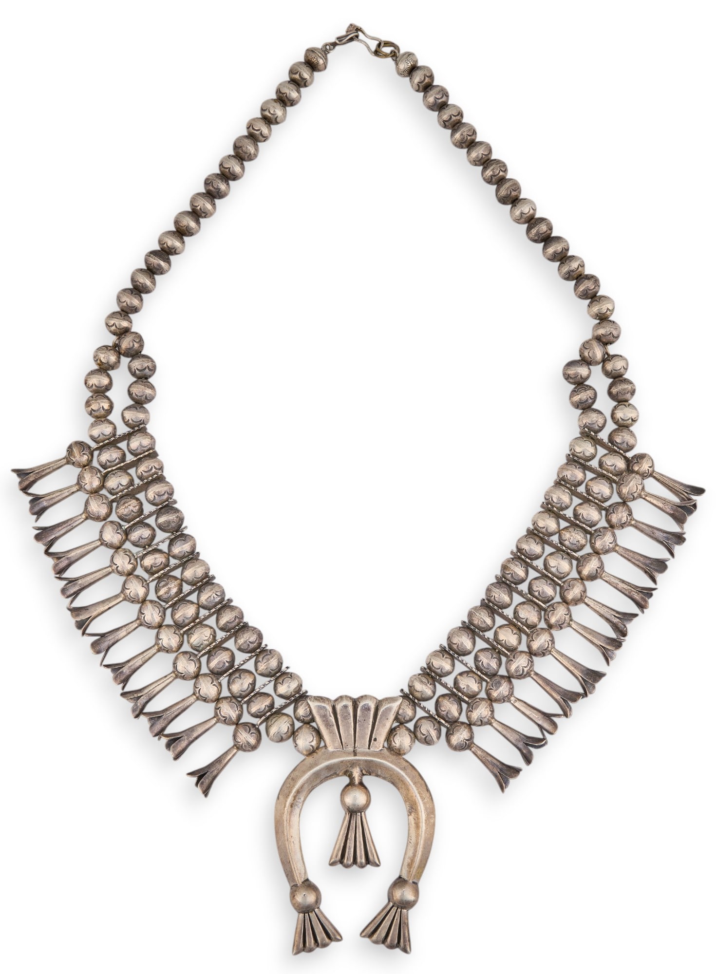 Sterling Silver Navajo Squash Blossom: Sterling silver Navajo squash blossom, with two rows of stamped beads, naja marked "LB" Chain length: 24 in. Total weight: 8.76 ozt Provenance: Property from a home in San Antonio, Texas