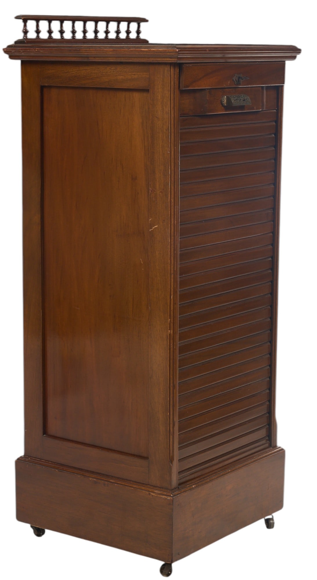 Antique Tambour Door Cabinet: Antique tambour door cabinet with a single drawer and a slatted door, supported on a plinth base with casters height 50 in. x width 20 in. x depth 20 in. Provenance: Property from a home in