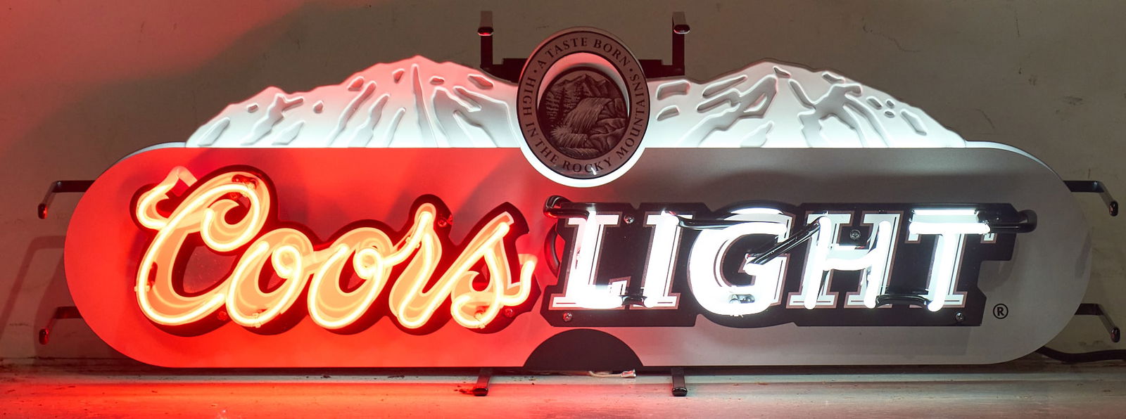 Coors Light Neon Sign: Coors Light Beer neon sign, with sTylized red and white neon, in working condition height 12 in. x width 33 in. x depth 9 in.