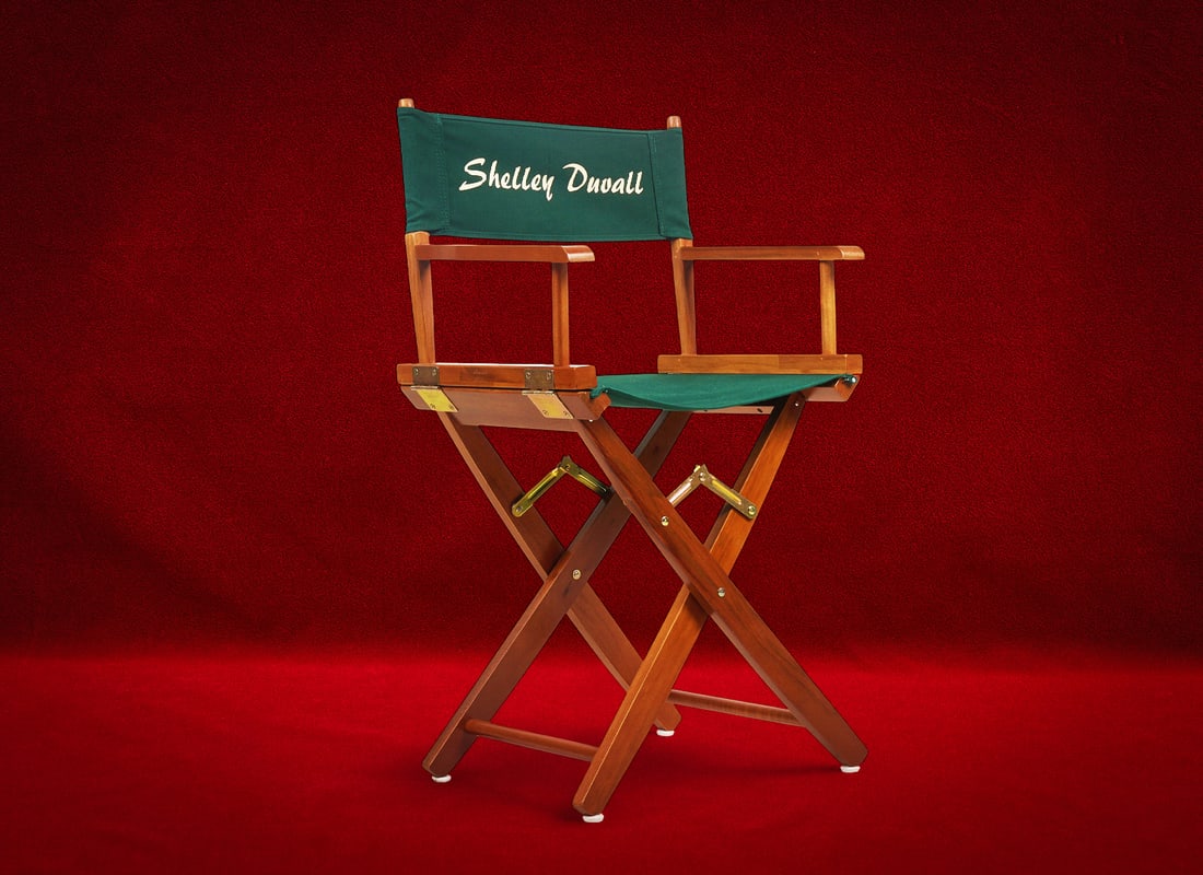 Shelley Duvall | Director's Chair: Shelley Duvall's director's chair, folding wooden frame with brass hardware, green canvas seat and backrest with stylized lettering reading "Shelley Duvall" height 38 in. x widt