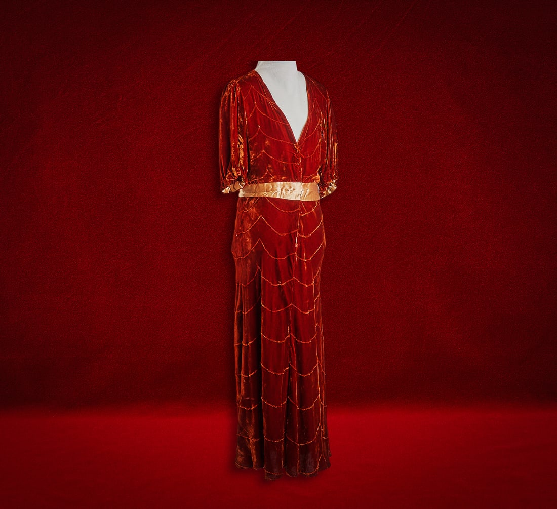 Shelley Duvall | Dress: Floor-length rust velvet gown, from the personal wardrobe of Shelley Duvall, scalloped with short puffed sleeves and contrasting satin waistband, button back, with accompanying photograph showing 
