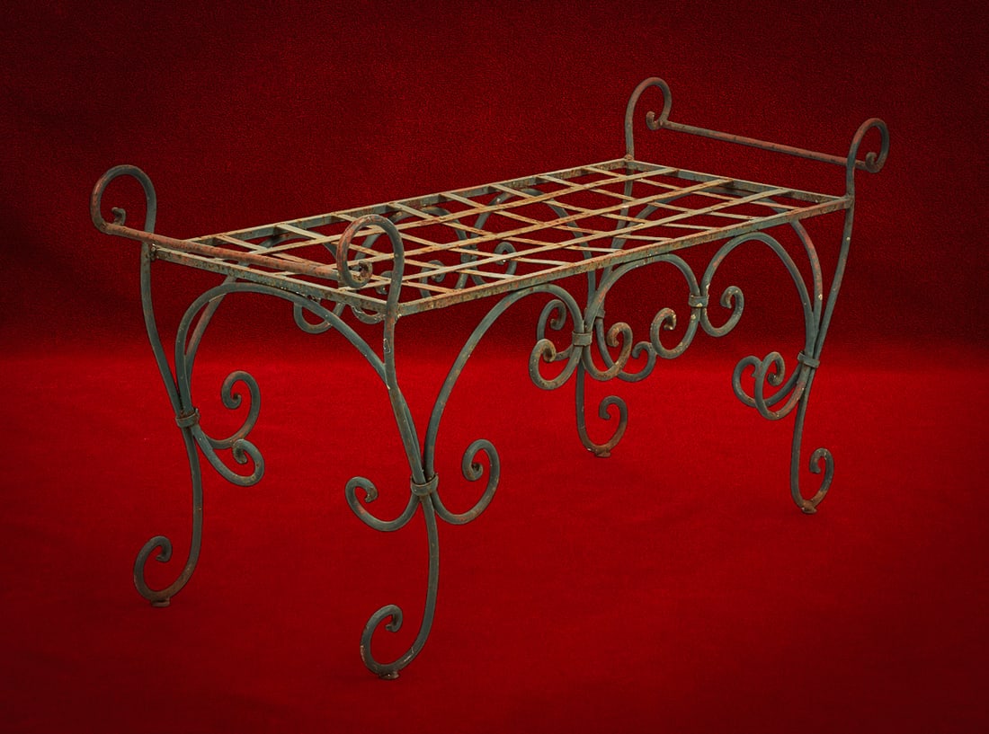 Shelley Duvall | Coffee Table: Wrought iron coffee table with decorative scrollwork sides and open lattice top, patinated green finish height 24 in. x width 49 in. x depth 17 in. Provenance: Property from the personal estate of cel