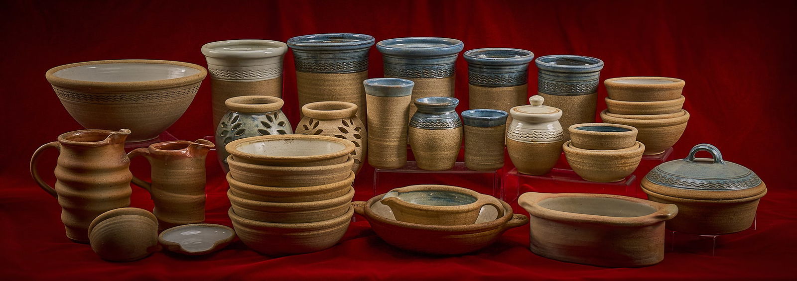 Shelley Duvall | Pottery: Extensive collection of hand-thrown stoneware pottery, most signed by the same artisan, all in coordinated earth tones with blue and cream glazes, including bowls, vases, pitchers and serving pieces,