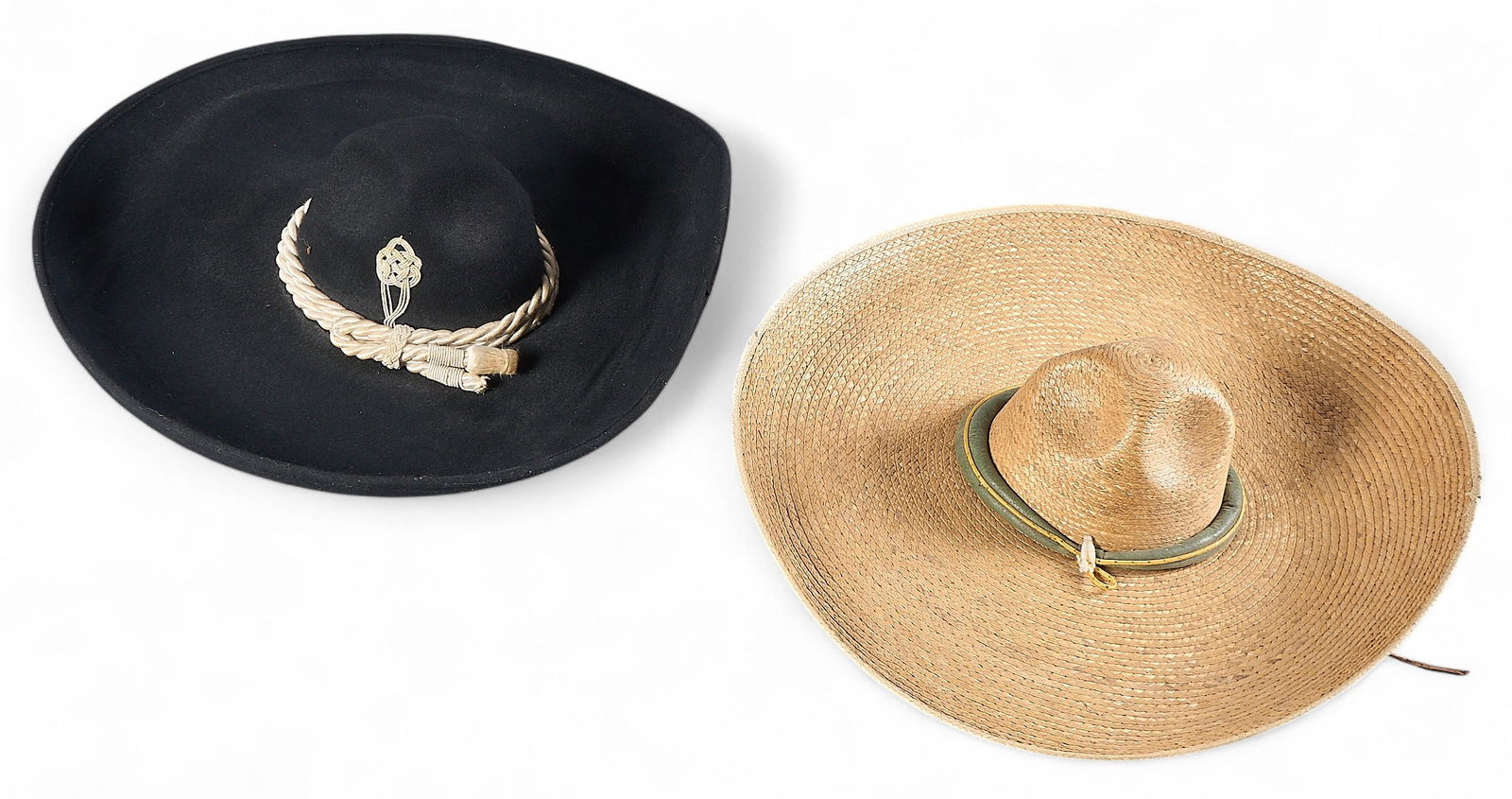 (2) Mexican Sombreros: Two Mexican sombreros, one black with decorative trim, and the other made of straw with a green band height 6 in. x width 23 in. x depth 22 in. / largest Provenance: Property from a home in