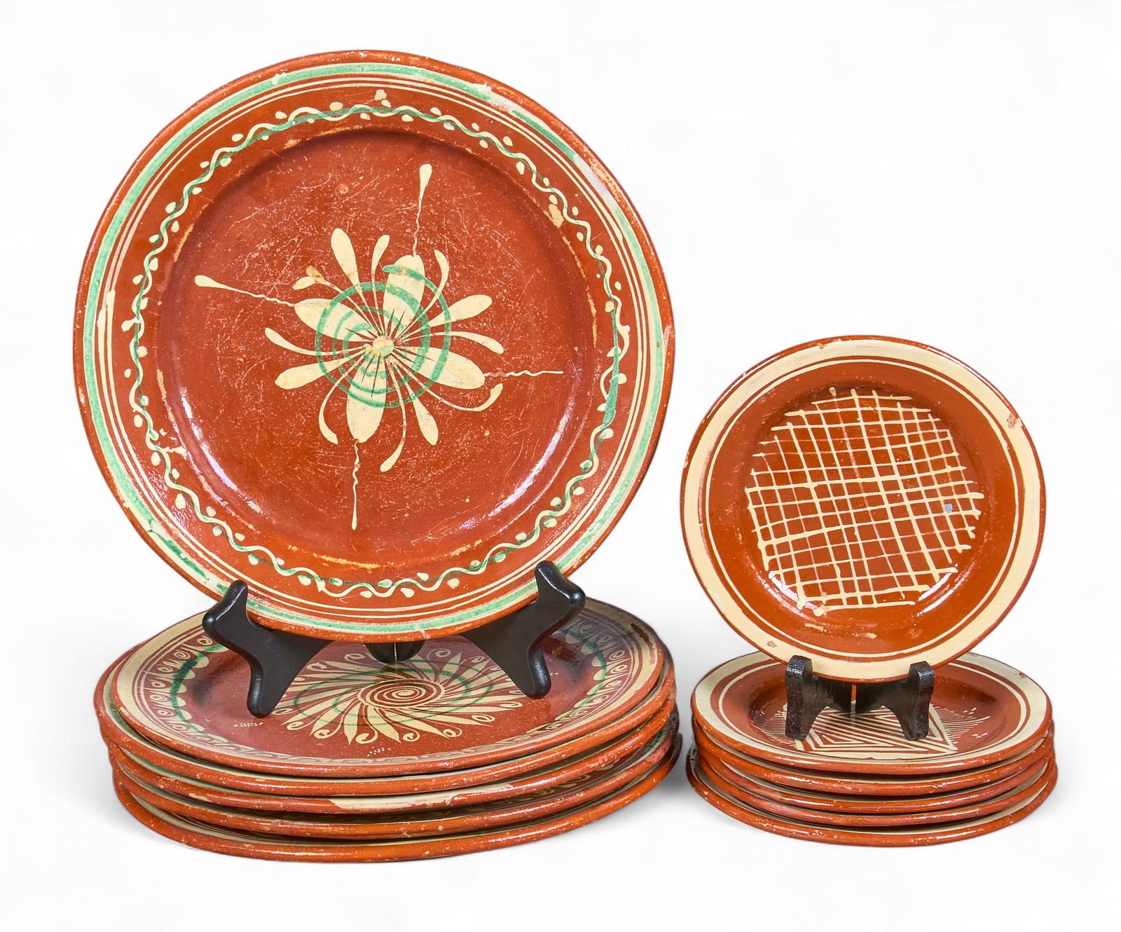 (12) Vintage Mexican Ceramic Plates: Collection of vintage Mexican (Metepec) decorative earthenware dishes, with six dinner plates, and six saucers, circa 1970s diameter 10 in. / each dinner plate diameter 6 in. / each saucer Prove