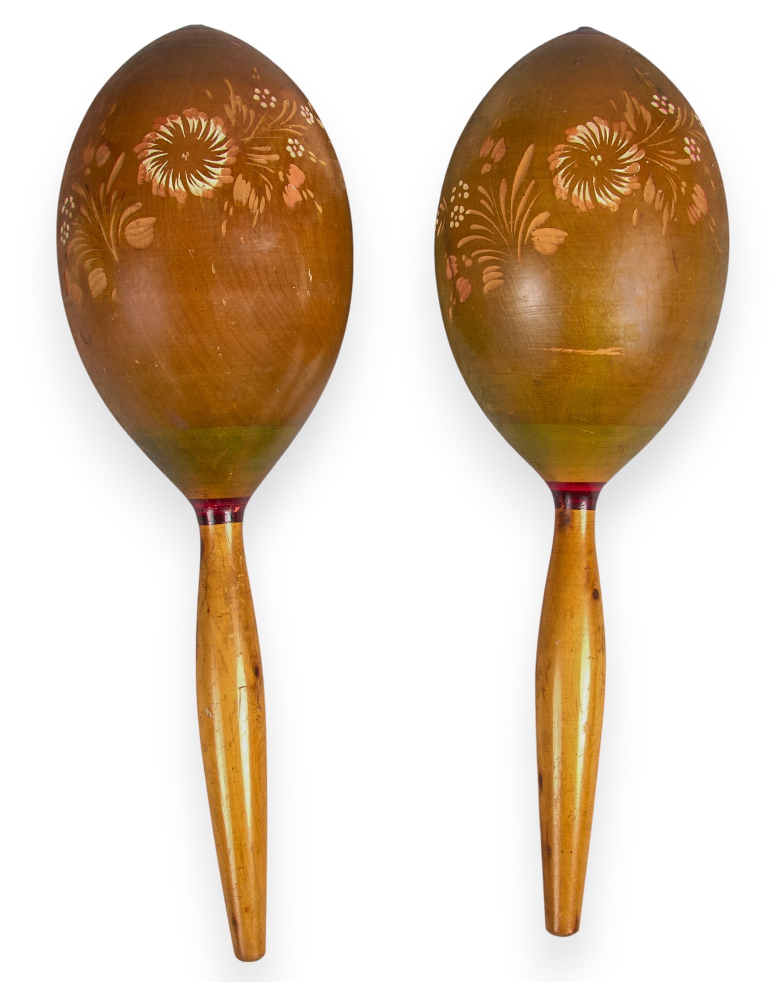 Pair of Mexican Maracas: Pair of burnished Mexican wooden maracas with carved floral motifs, circa 1950s length 15 in. x width 5 in. / each Provenance: Property from the noted Latin American arts col