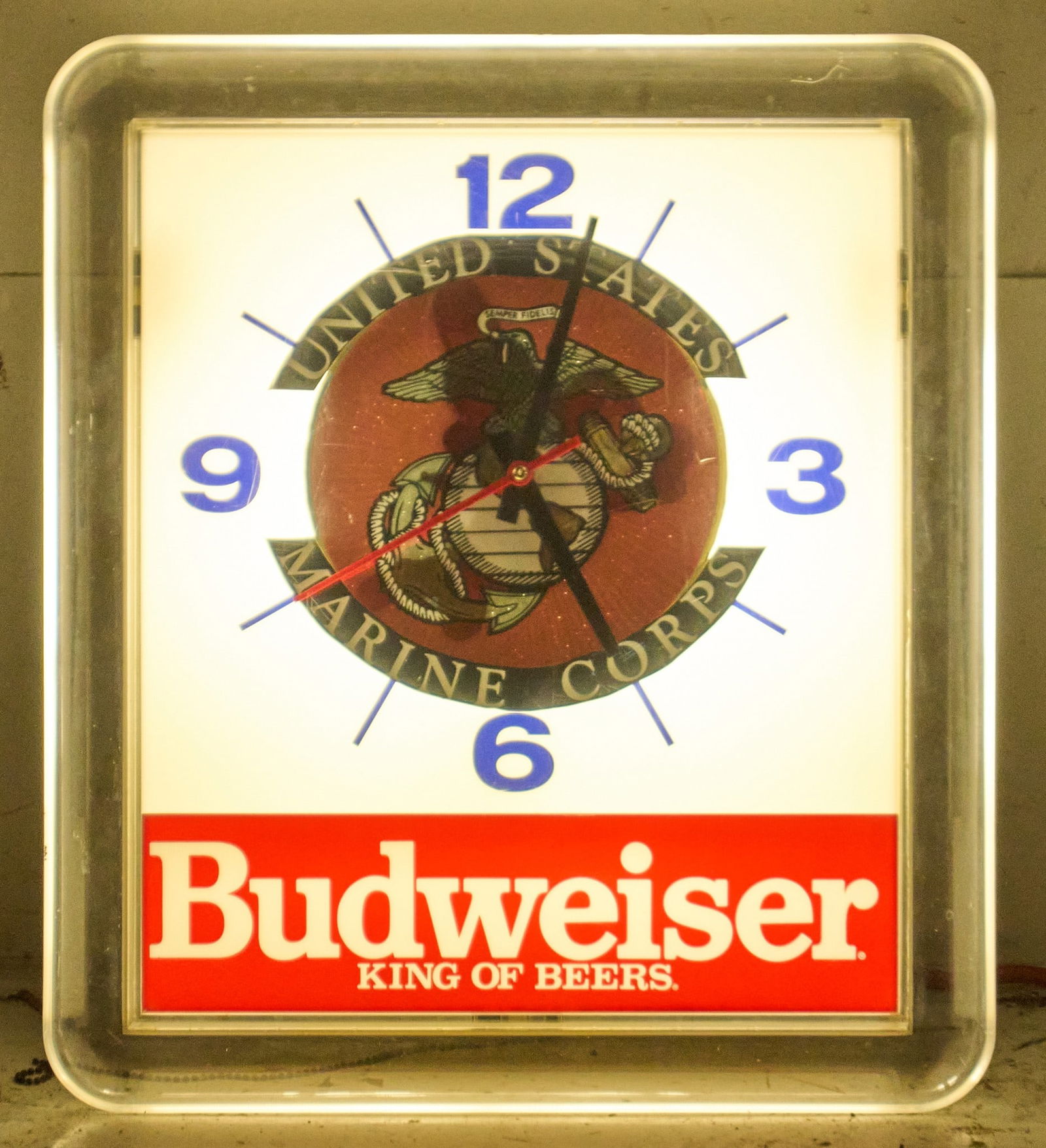Budweiser Marine Corp Illuminated Clock: Vintage Budwesier Beer illuminated wall clock with United States Marine Corp graphic on clock face height 20 in. x width 17 in. x depth 5 in. Provenance: Property from a home in San Antonio, Tex