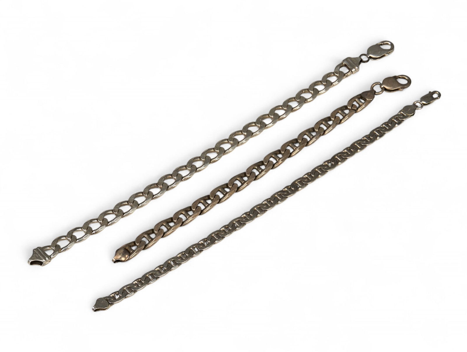 (3) Men's Sterling Silver Chain Bracelets: Collection of three sterling silver men's bracelets, to include two mariner link chain bracelets, and a Cuban link chain bracelet, each marked "Italy 925" circumference: 9.5 / large