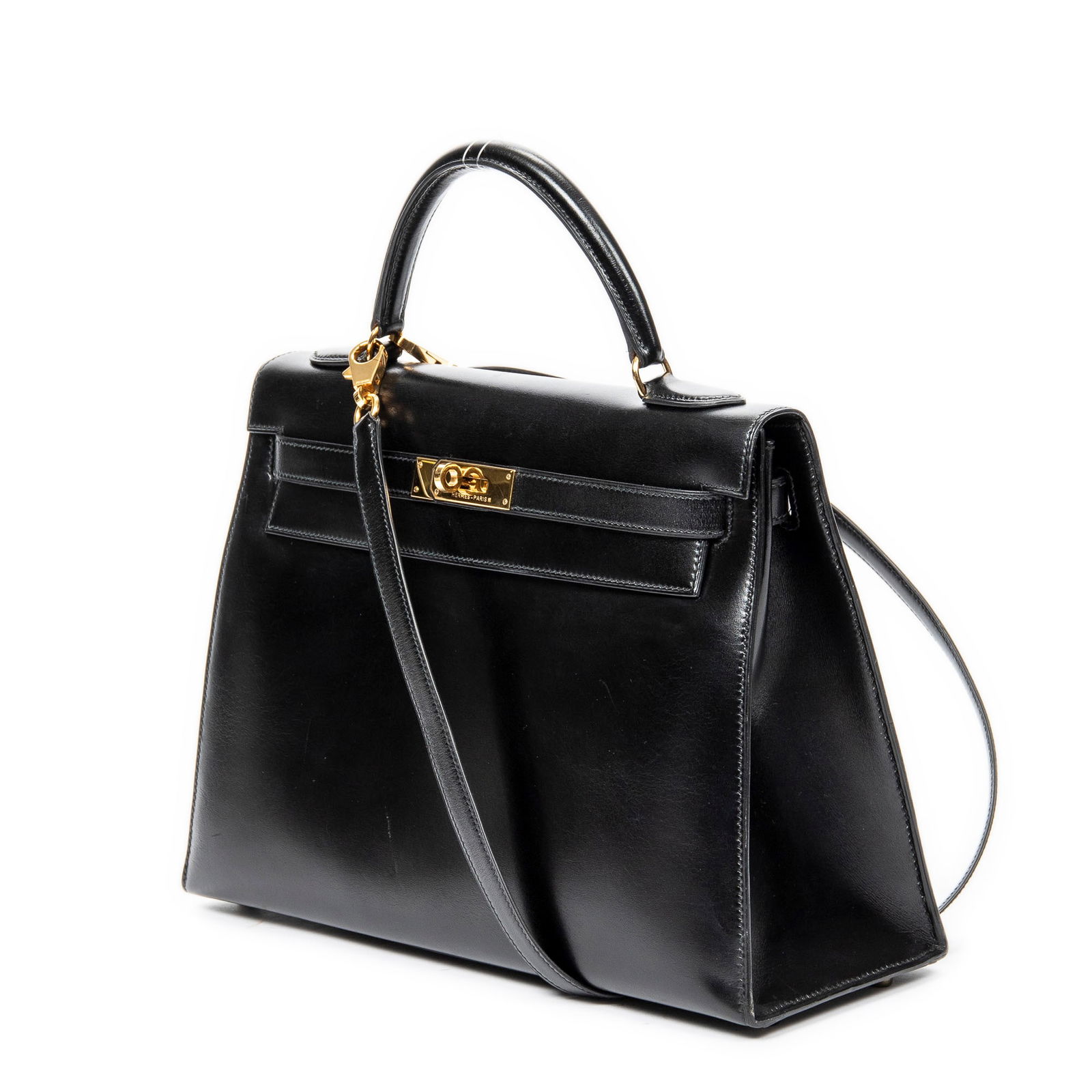 Hermes Kelly Sellier 32 Handbag: Hermes Kelly Sellier handbag in black box leather with black leather handles, and gold hardware, marked Stamp U in Circle (1991), includes strap; third-party authenticated 12.5 in. x 8.75 in. x 4.5 in