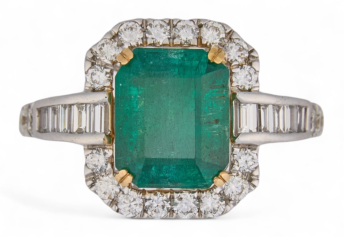14K Emerald and Diamond Ring: 14K white gold emerald and diamond halo ring featuring central emerald (approx. 11.42 x 9.93 mm) with round and baguette cut diamond halo, size 7, marked "14K" Total weight: 5.1 g Prov