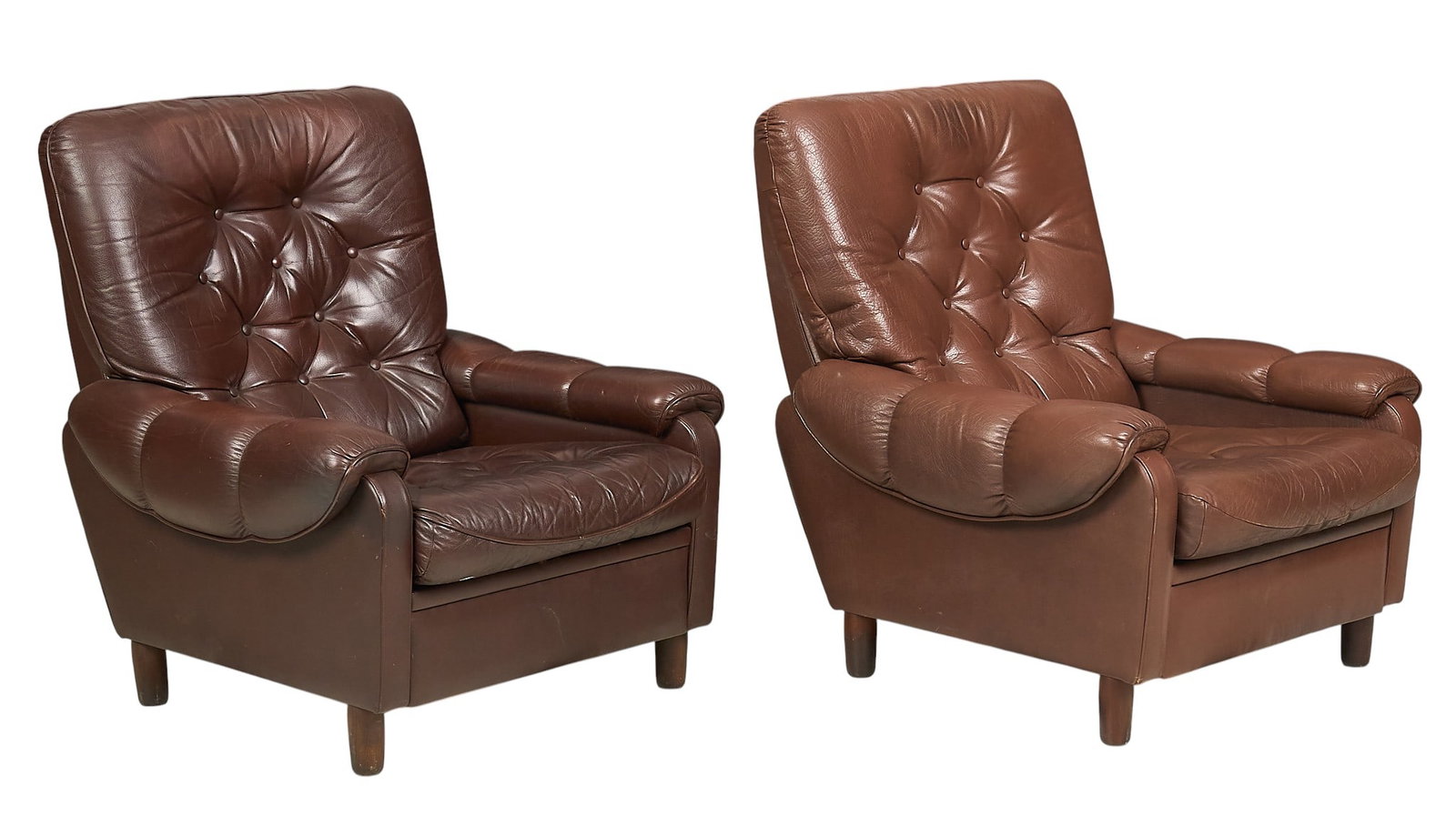 Pair of Danish Mid-Century Leather Club chairs: Pair of Danish mid-century club chairs with tufted brown leather upholstery, with one a slightly lighter shade, both supported on block legs height 37 in. x width 33 in. x depth 38 in. / each 