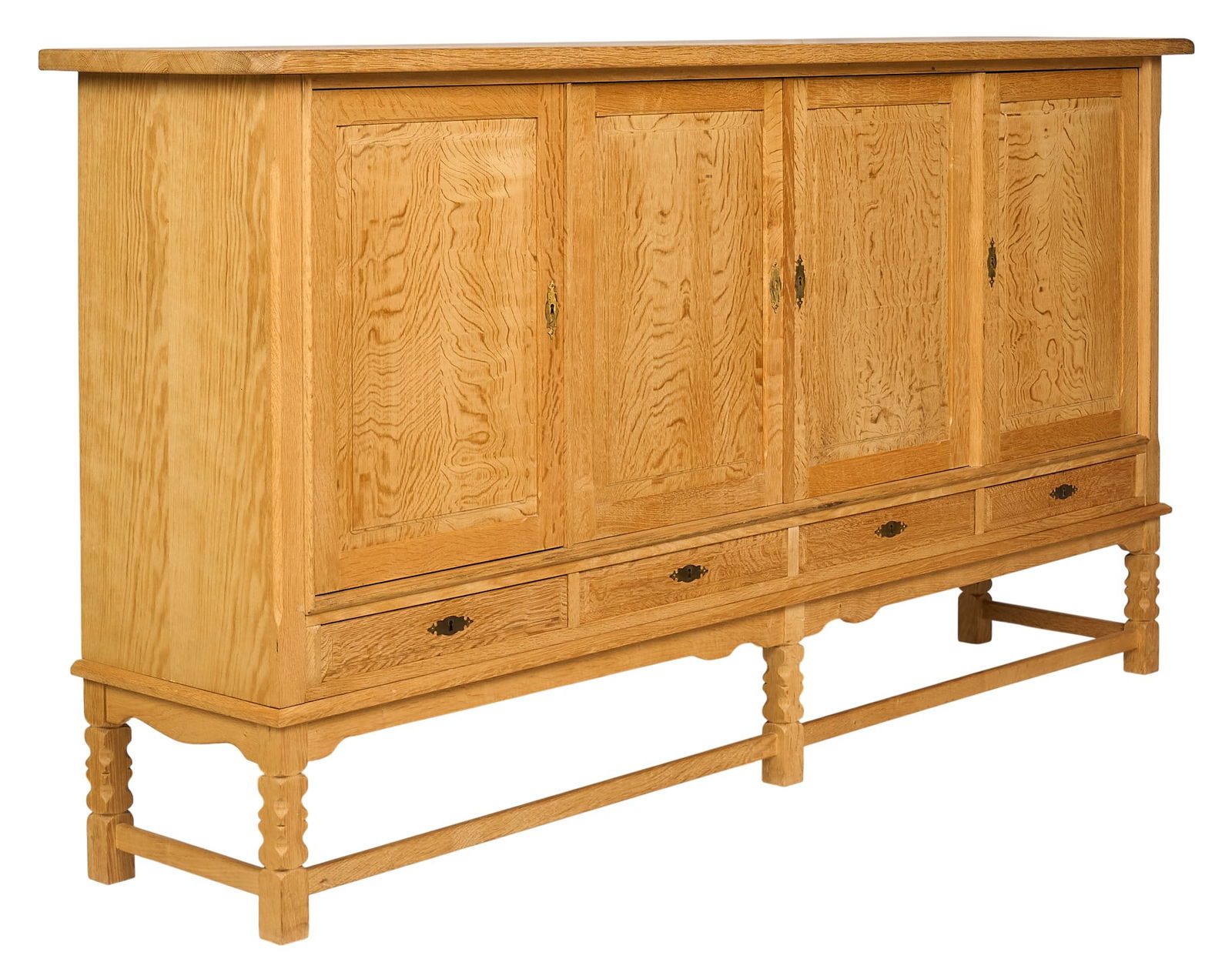 Henning Kjaernulf, Mid-Century Credenza: Henning Kjaernulf (Denmark) oak mid-century credenza with four cabinet doors opening to three divided sections with shelved interior, and four l