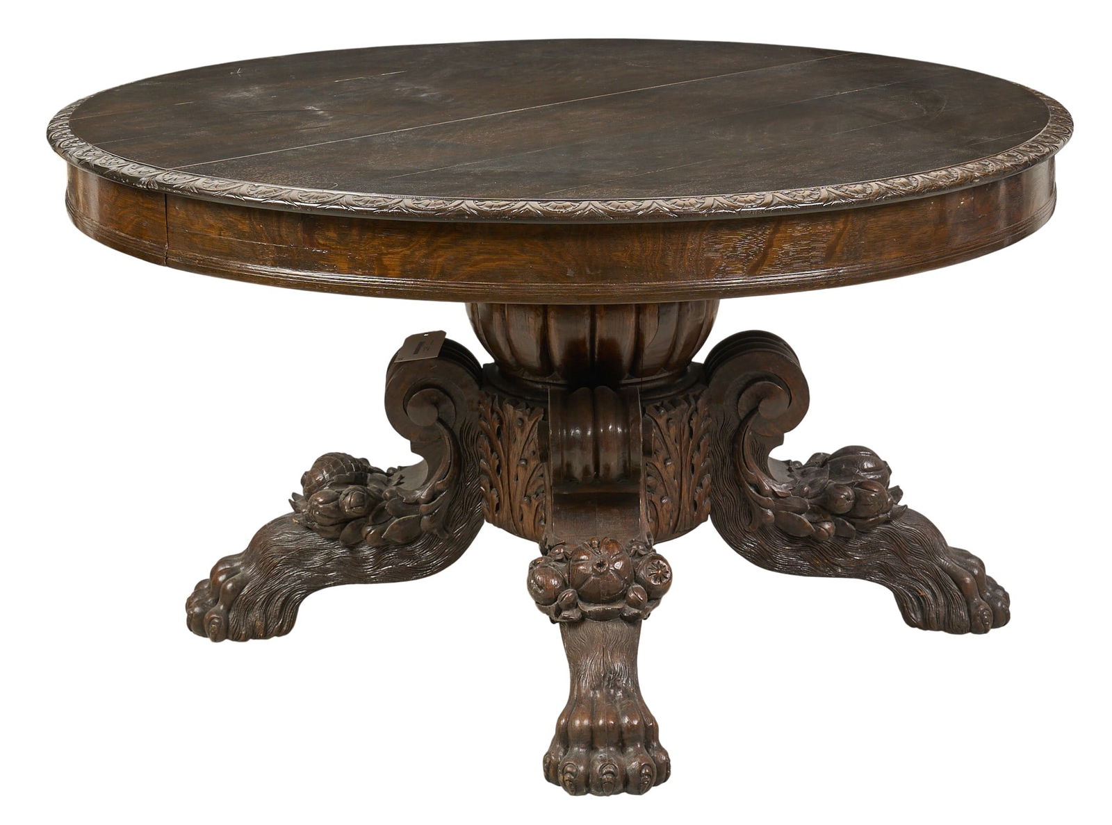 Antique Carved Oak Dining Table with Lion Paw Feet: Antique dining table with a round top and a heavily carved base with lion paw feet and leaves for extension height 30 in. x width 54 in. x depth 54 in. / extends to width 125 in. Prove
