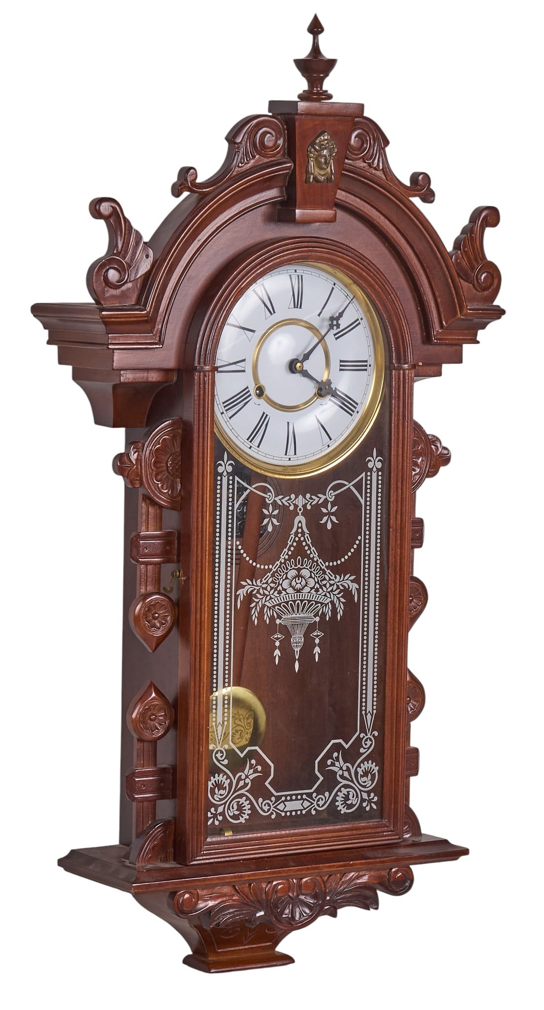 Gingerbread Kitchen Wall Clock: Gingerbread kitchen wall clock with ornate wood carving, pendulum, and glass face with decorative motifs, includes hardware for hanging height 33.5 in. x width 18.5 in. x depth 5.5 in. Prov