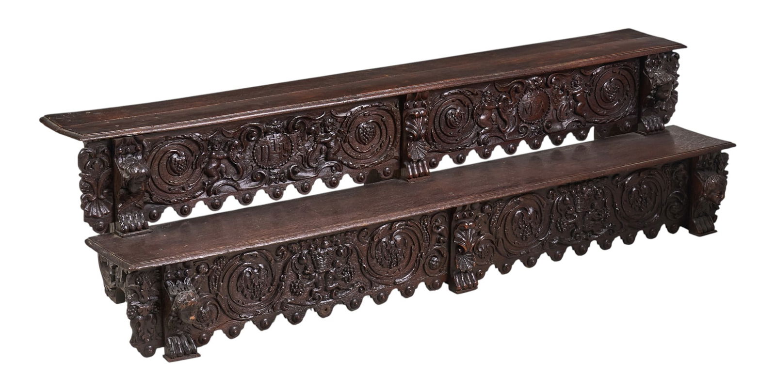 Carved Window Seats: Pair of ornately carved antique window seats, circa 19th century height 15 in. x width 56 in. x depth 15.5 in. Provenance: Property from a prominent Nuevo Laredo, Mexico family involved in