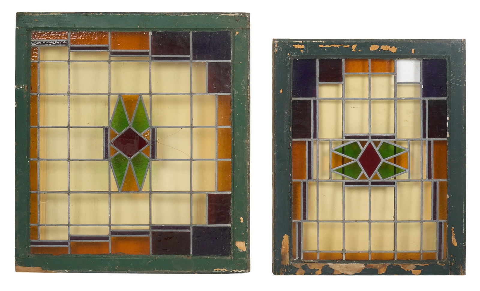 (2) Stained Glass Window Panels: Set of two stained glass window panels with geometric designs in amber, green, burgundy, and blue, each panel set within a painted wooden frame height 37.5 in. x width 33.5 in. x depth 1.5 i