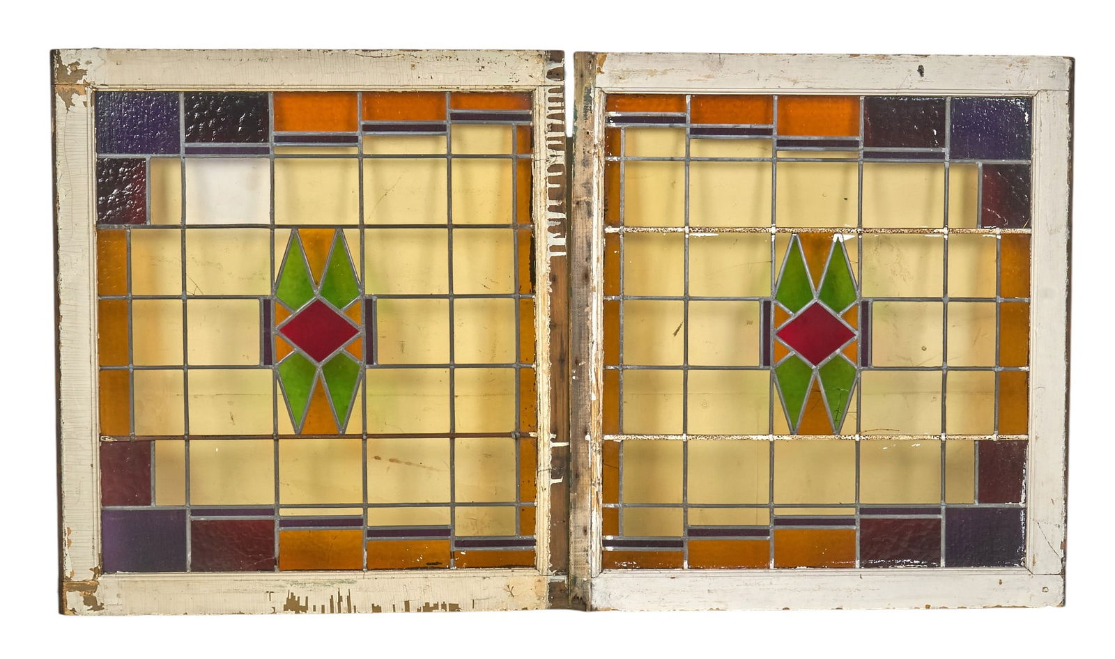 Pair of Arts & Crafts Stained Glass Window Panels: Pair of Arts & Crafts style stained glass window panels with geometric designs with red, green, orange, and purple glass, set in painted wooden frames height 38 in. x width 33 in. x dept
