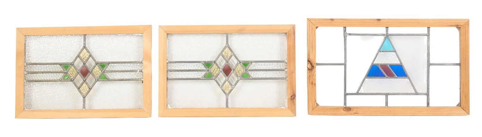 (3) Stained Glass Panels: Three stained glass panels, with one pair with matching pattern, and one single height 15 in. x wdith 24 in. x depth 1.5 in. / largest Provenance: Property from a home in Hollywood Park, Texas