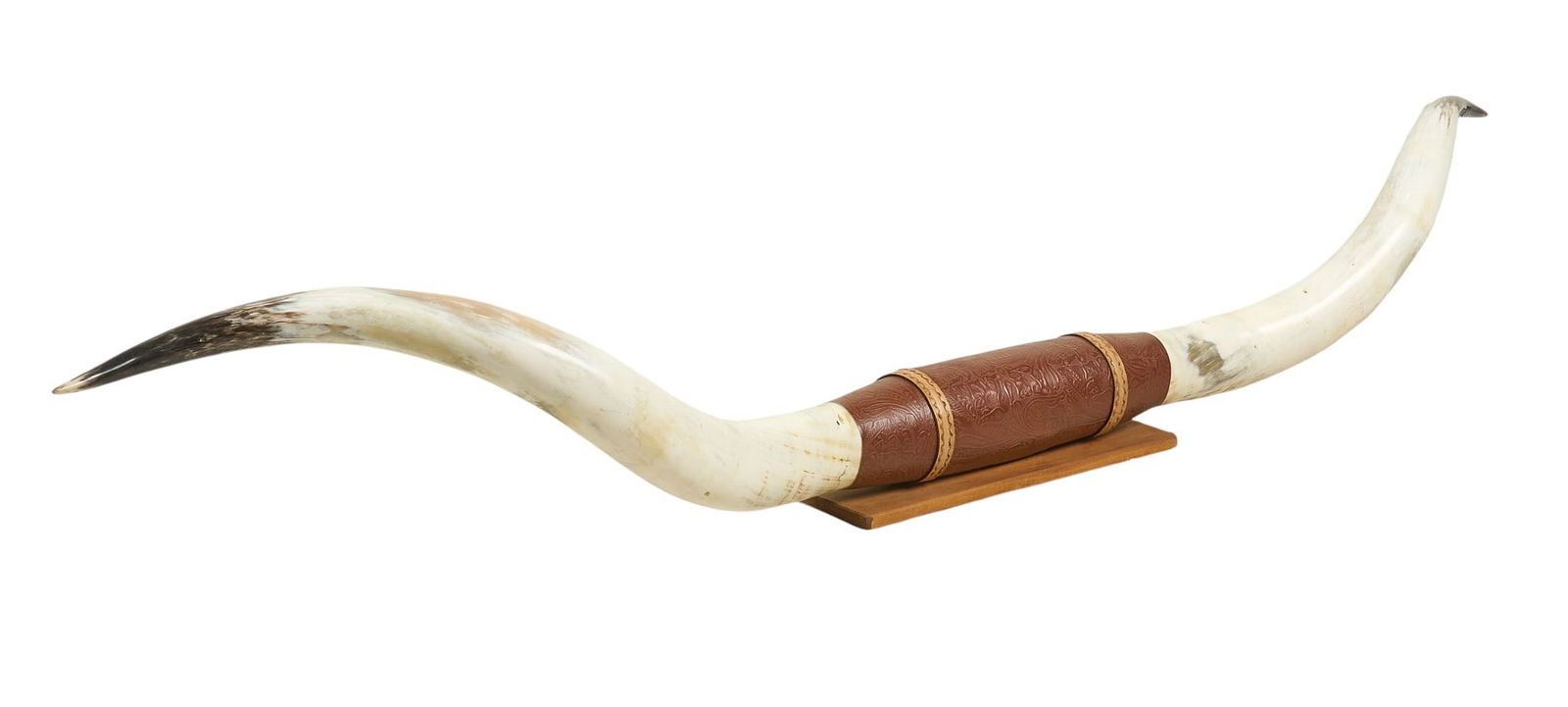Longhorn Mount: Longhorn mount, with tooled leather detail to center height 8.5 in. x width 14 in. x depth 89 in. Provenance: Property from a home in Wimberly, Texas
